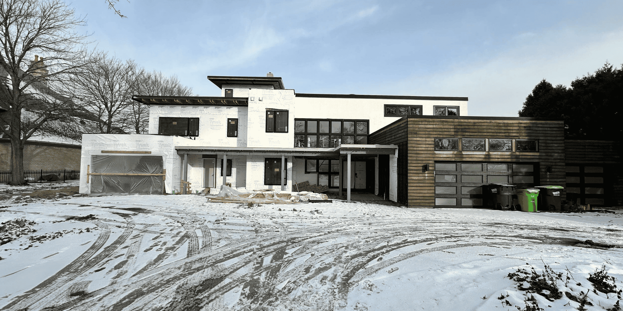 Home construction in winter time with snow - Essential Features Every Luxury Lakefront Home Should Have - Payne & Tompkins - Ohio Design Build Firm