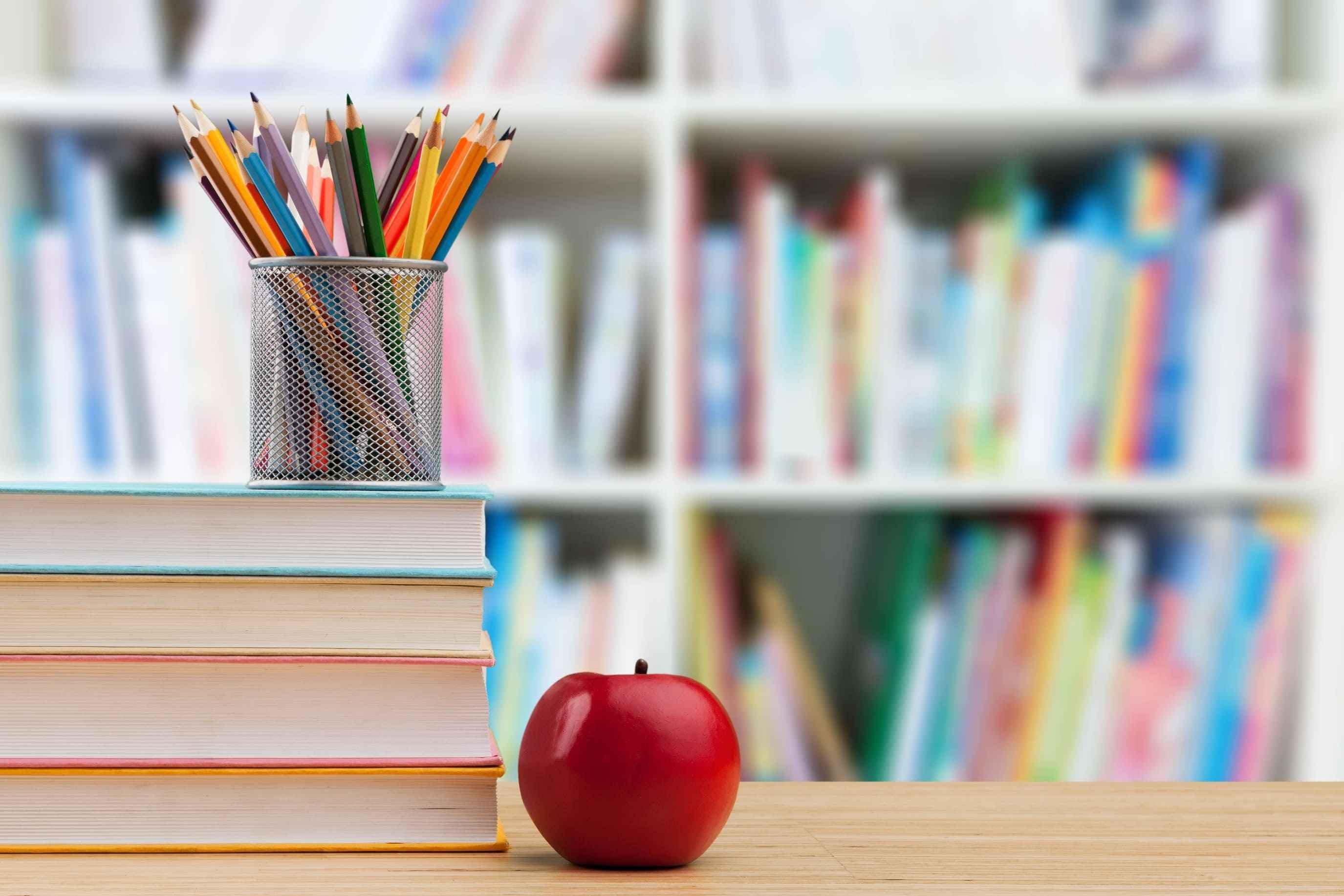 Best Private Schools in Cleveland Ohio - Payne & Tompkins - Ohio Design Build Firm - photo of apple and pencils on top of books