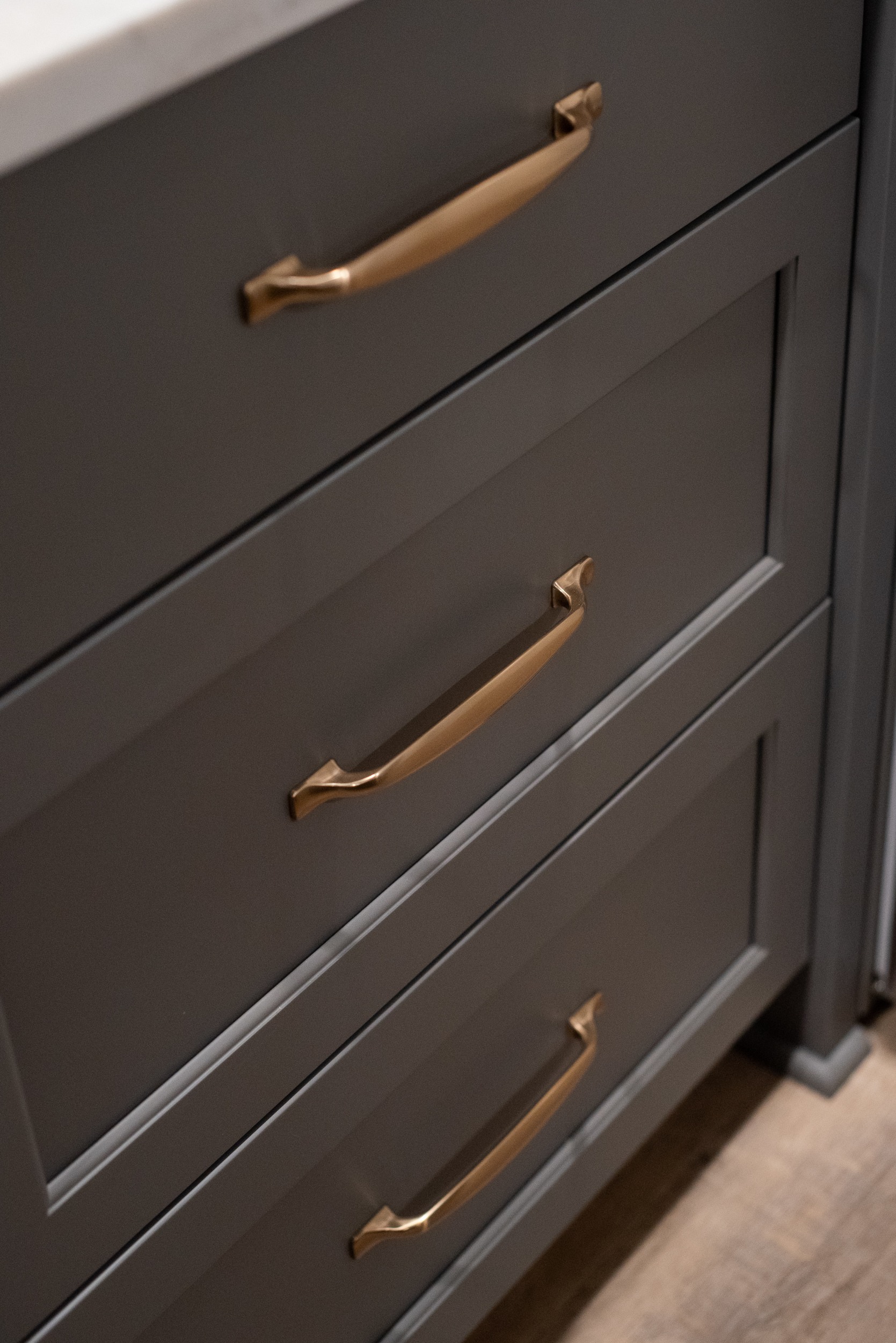 Dark gray cabinets with copper hardware