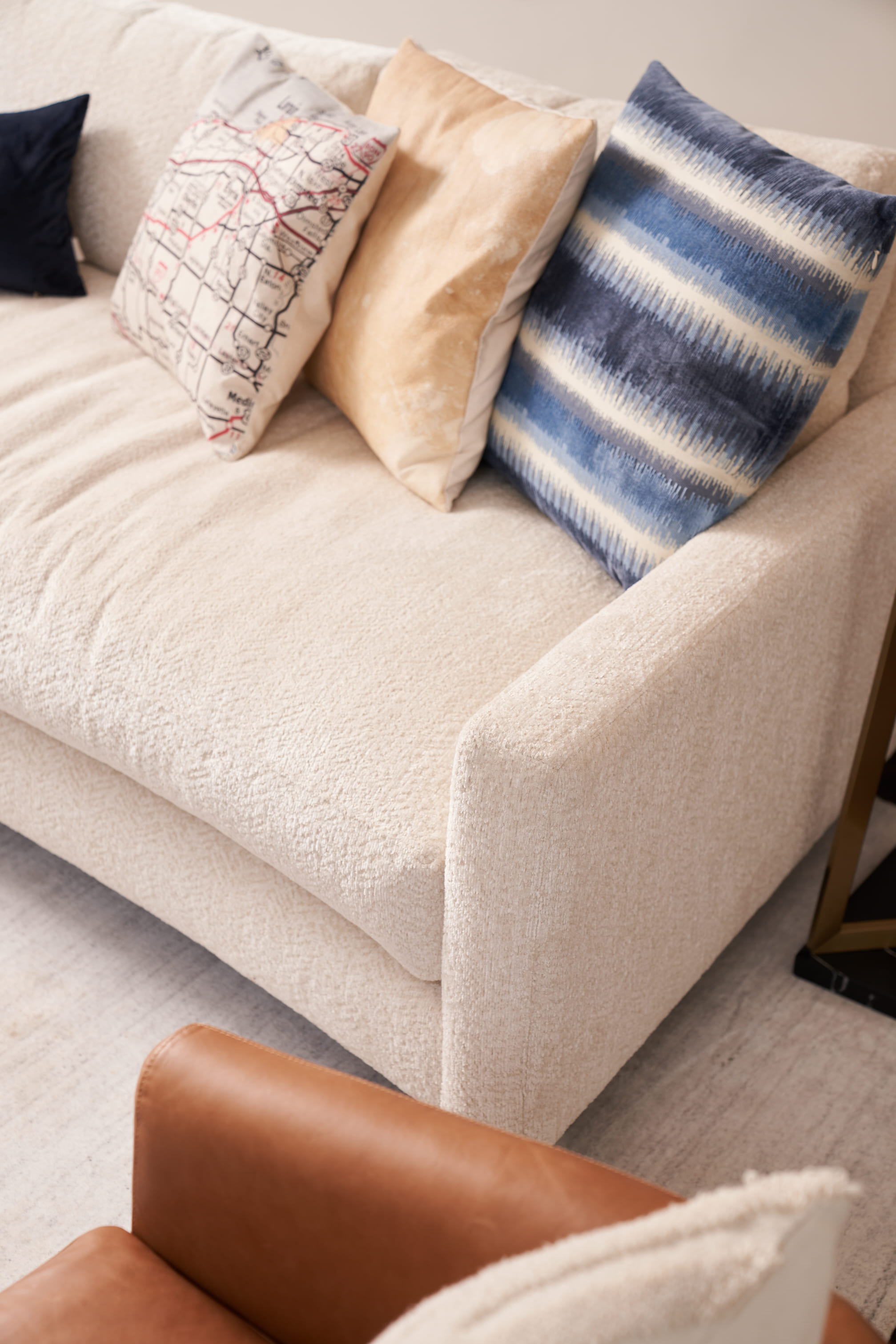 beige couch with pillows