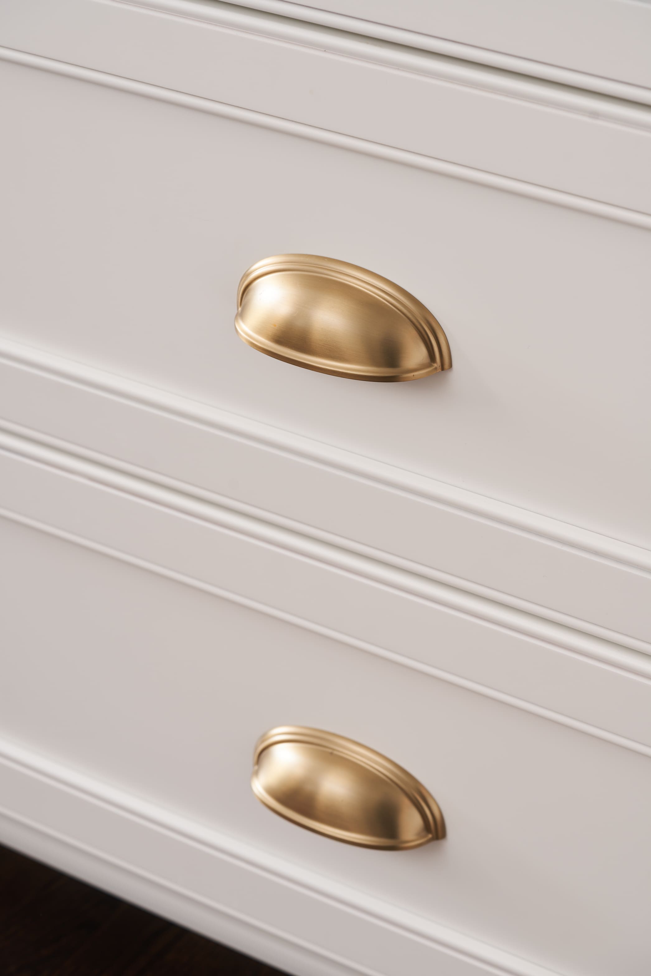 gold hardware on white cabinet