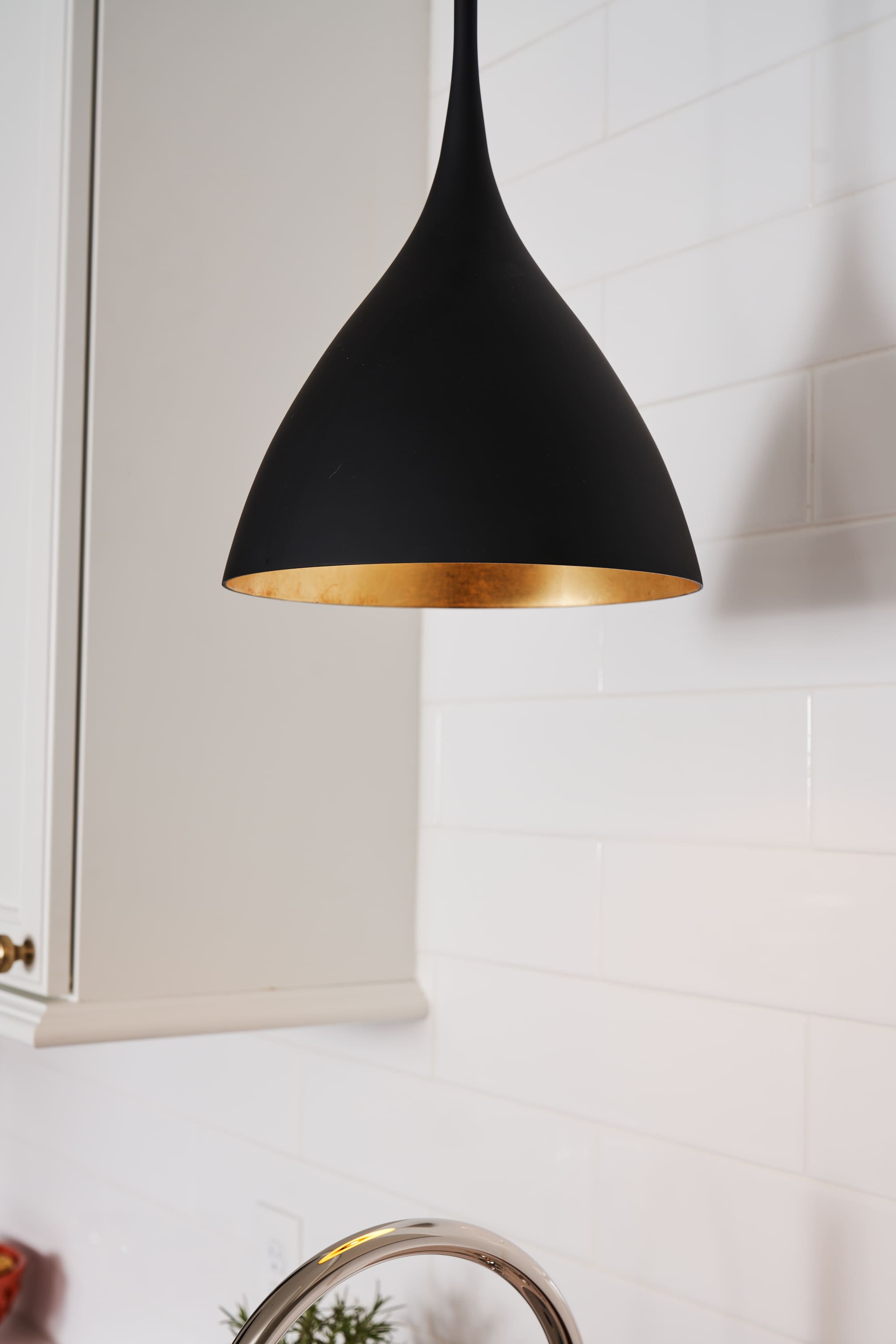 black accent light with gold in kitchen renovation