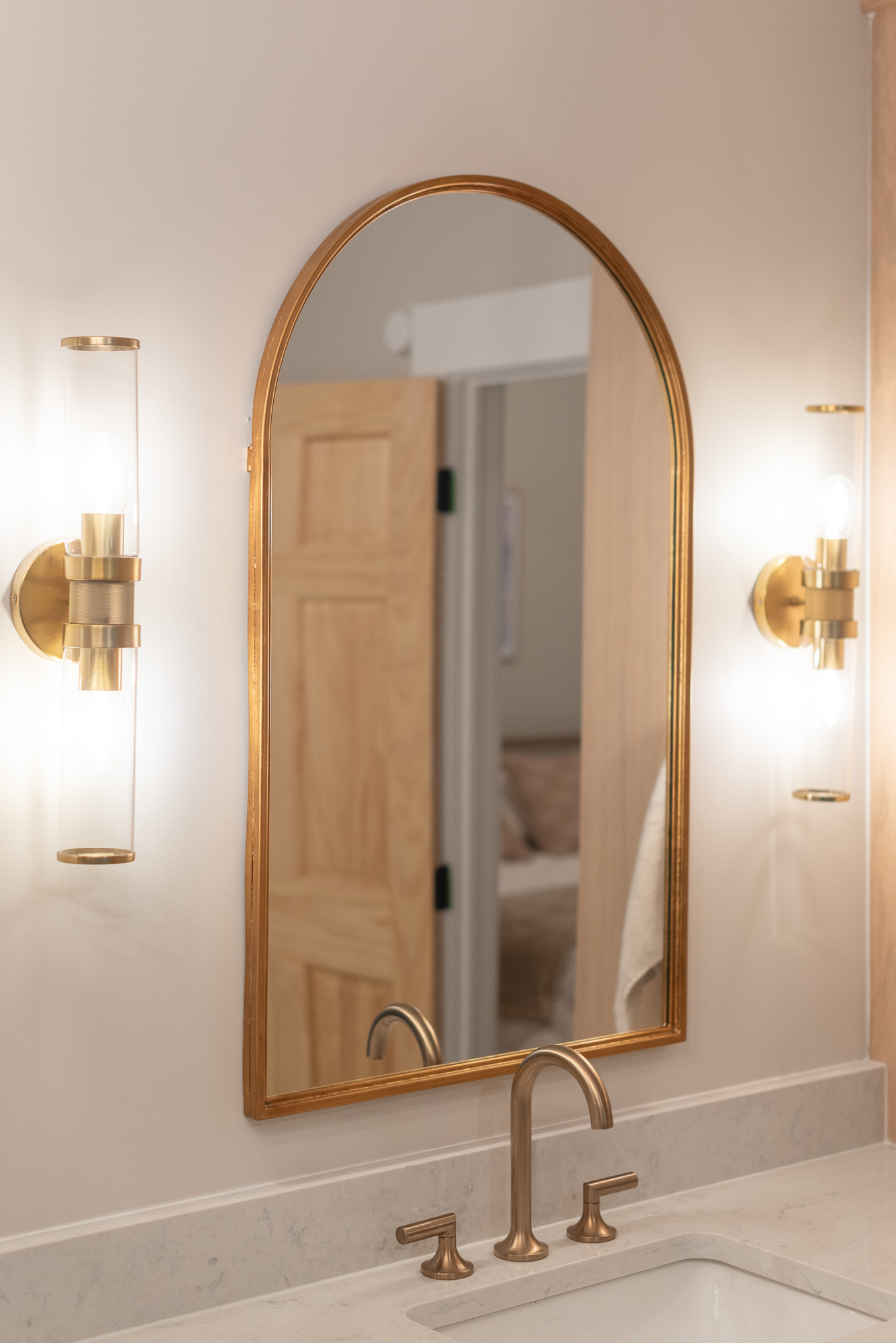 gold arched vanity mirror