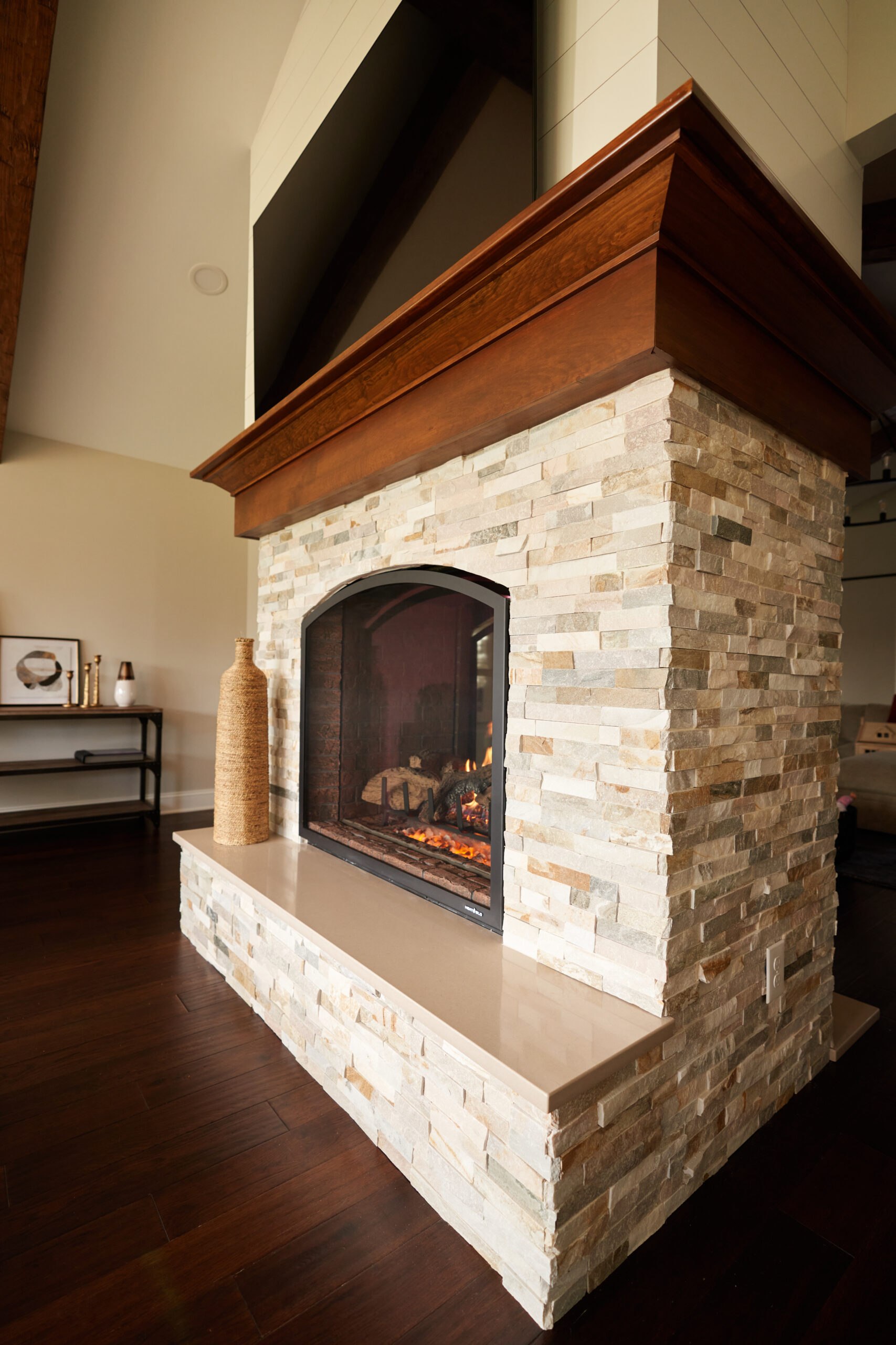 Custom Stone Clad Fireplace with Wooden Mantel in Ohio Renovation