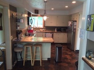 dated kitchen with small peninsula seating