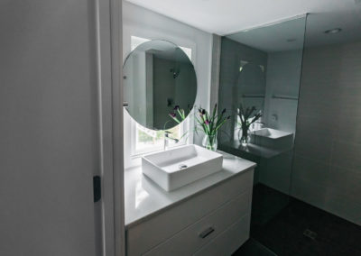 raised sink vanity with circular mirror