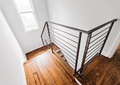 wood staircase with black iron railing