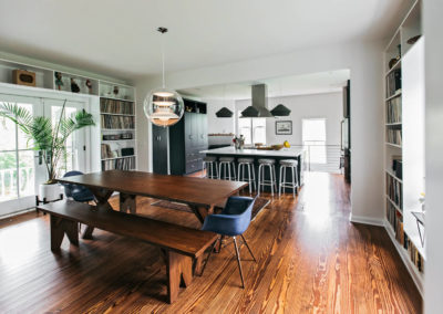 modern kitchen open to dining area with wood picnic style table