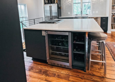 large kitchen island with built in wine fridge and rack