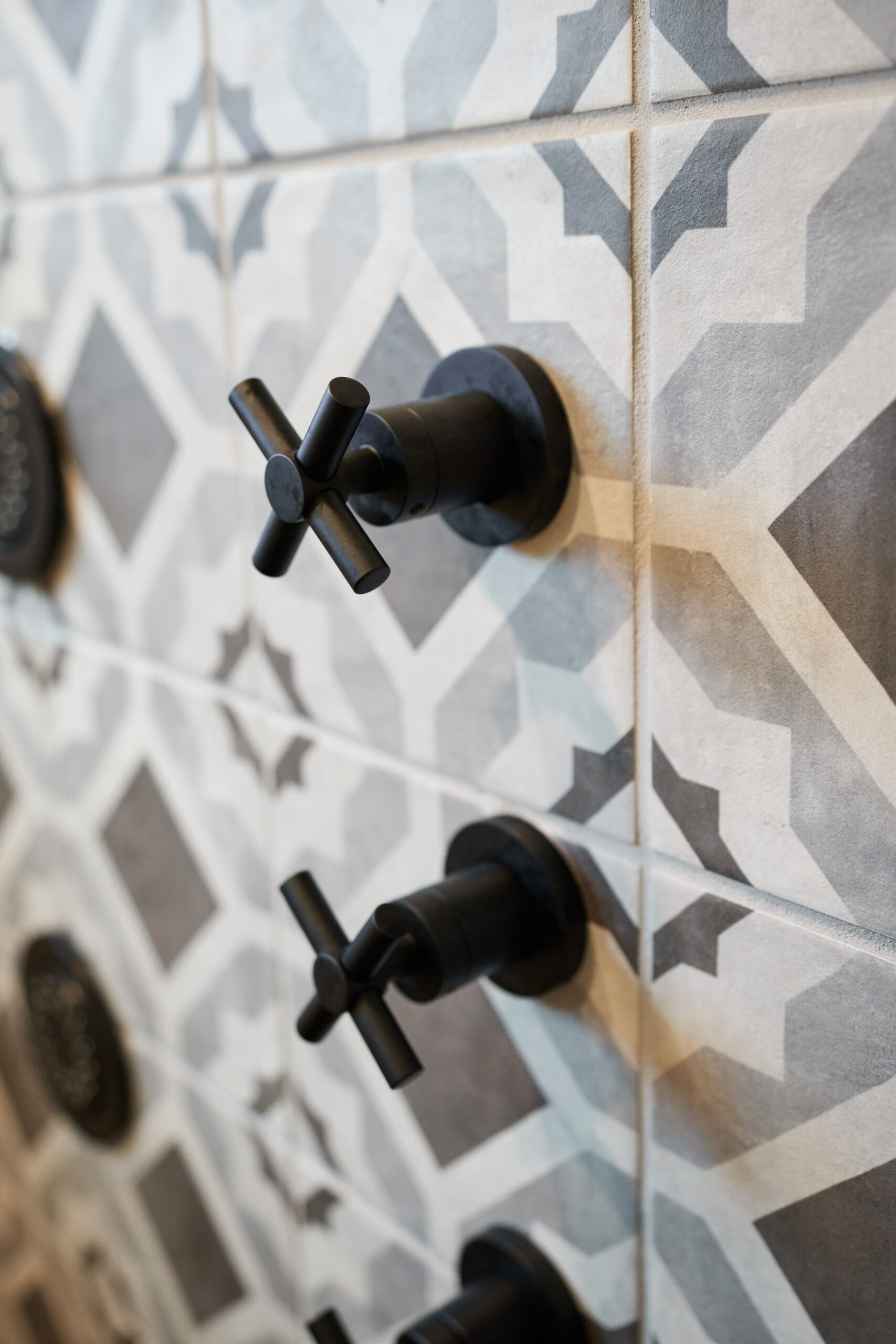 Encaustic Tiles in Remodeled Shower with Fixtures 