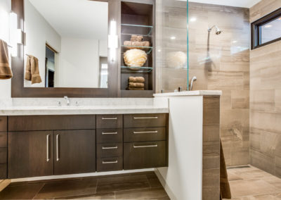 floating brown single sink vanity next to tile shower