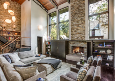 modern industrial living room with stone fireplace surround