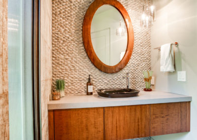 bathroom with angled wall and floating vanity