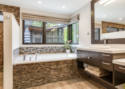 master bathroom tub with stone and tile details