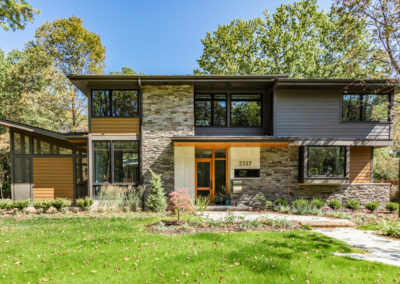 modern home exterior with large windows and thin stonework