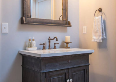 half bathroom with rustic single sink vanity