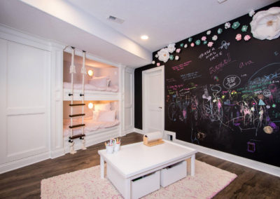 custom built in bunk bed room with chalkboard wall
