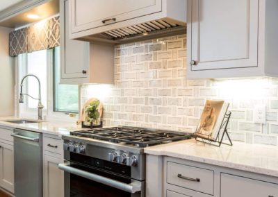 large stainless steel oven and range in gray kitchen