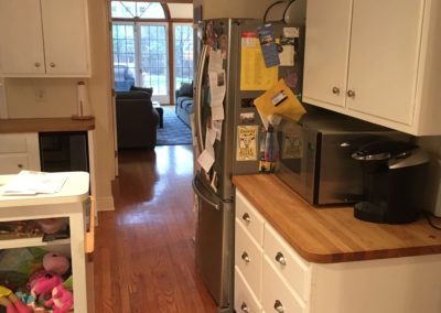 kitchen with white cabinets and butcher block countertop