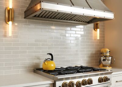 Metal Range Hood with Gray Tiled Backsplash