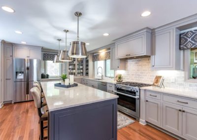 two toned gray kitchen with large island and oven range