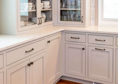 corner of kitchen with light gray cabinets