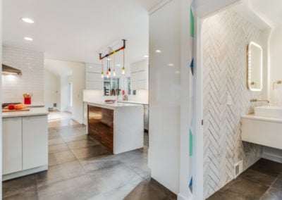 modern kitchen and half bathroom with tile wall