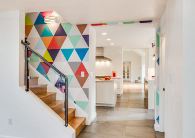 modern staircase with multicolored triangle pattern wallpaper