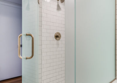 white subway tile shower with octagonal tile floor