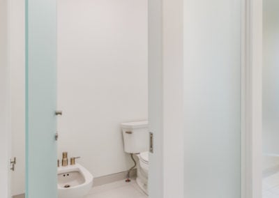 white bathroom with frosted glass door