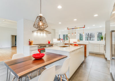 white modern kitchen with center island and table