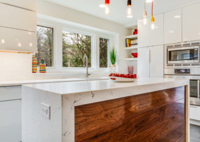 modern kitchen with white cabinets and double oven