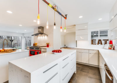 white modern kitchen remodel with red oven