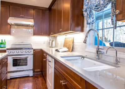brown shaker style kitchen cabinets and white subway tile backsplash