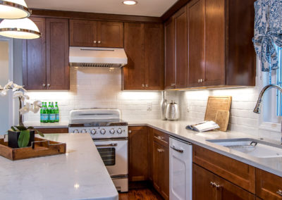 brown kitchen cabinets with retro white appliances