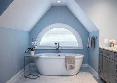 light blue master bathroom with freestanding tub