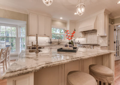 white kitchen with square seating island