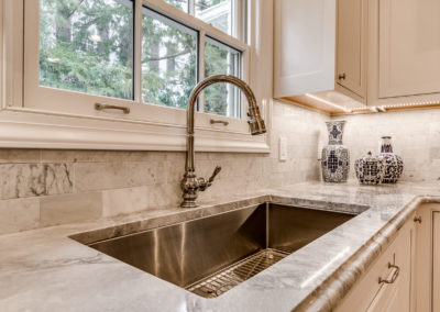 undermount stainless steel sink in modern white kitchen
