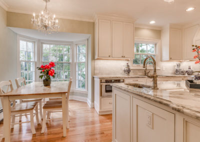 white kitchen and dining area renovation with chandelier