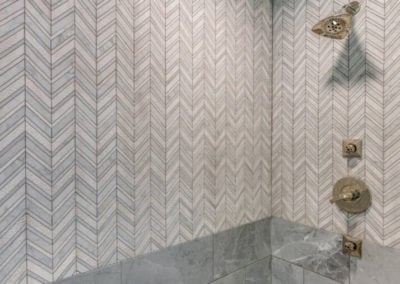 walk in shower with mixed gray tile designs