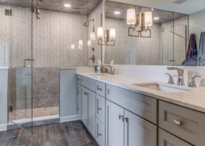 master bathroom with double sink vanity and glass door shower