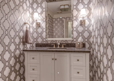 half bath with gray patterned wallpaper