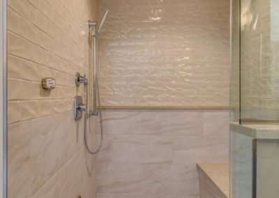 beige tile shower with bench