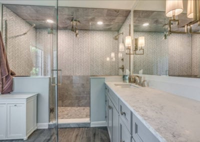 luxury master bathroom shower with mixed gray tile patterns