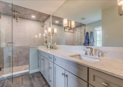 master bathroom with double sinks and large mirror