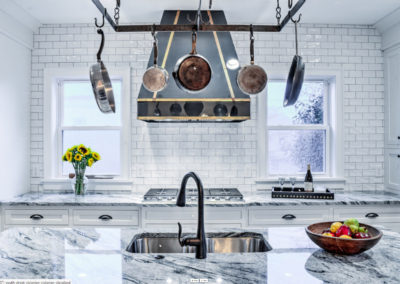 modern kitchen with black and gold stove range hood