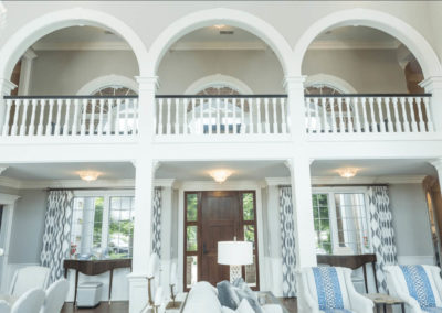 georgian colonial style balcony overlooking living room and entryway