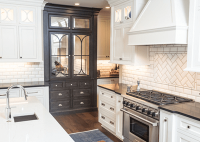colonial kitchen remodel with white cabinetry and brown dog laying on rug