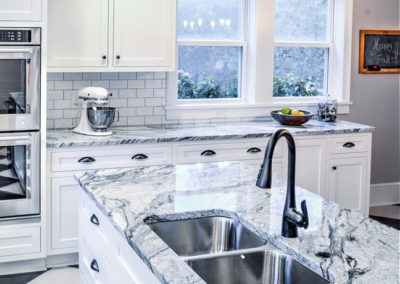 modern retro kitchen with marbled black and white counters and checkered floor