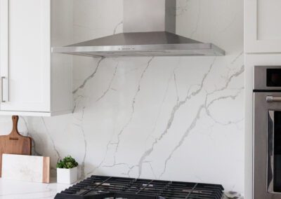 Large Format Marble Look Backsplash in White Kitchen